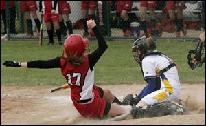 St. Ursula catcher Audrey Tucholski tags out Elyria's Tareyn McKenzie after a throw from second baseman Chelsey Jones in the bottom of the 11th inning.
