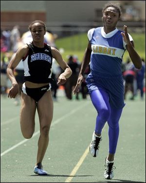 Libbey's Danyelle McGary wins the 100-meter dash at the regional ahead of Darcell Formby of Cleveland Rhodes.