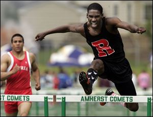 Darryl Elston of Rogers heads to a first-place finish in the 300-meter hurdles in the Division I regional at Amherst.