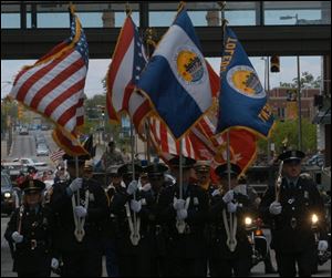 Toledo police lead the parade to honor those who have served in the U.S. military.