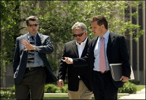 Two unidentified businessmen, left, walk next to their attorney, Jeff Zilba, who declined to identify
the pair. The Blade is attempting to identify these individuals who testified before the grand jury.
Anyone with information about them is asked to contact The Blade at 419-724-6050.
