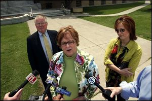 Lucas County Republican leader Sally Perz, flanked by lawyer Barry Savage and daughter Allison
Perz, makes a statement after her grand jury testimony.