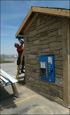 Todd Huling puts some finishing touches on the water and sewer district's first WaterShed unit on State Rt. 582.