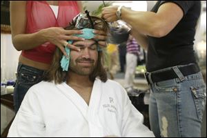 Boston Red Sox center fi elder Johnny Damon receives a makeover, but refuses to get his hair cut.