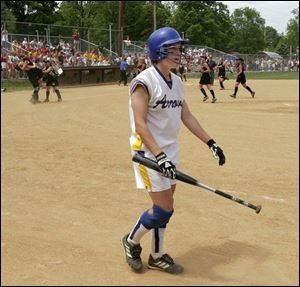 St. Ursula's Alyssa Frobase heads for the dugout while Harrison players celebrate a victory in a Division I state semifinal.