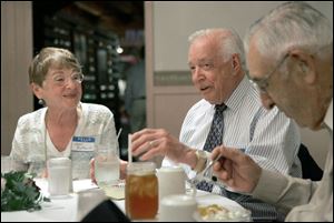 Television personality and author Hugh Downs, center, chats with Mary Jean Butturff and Odos Craig at yesterday's Shawnee High School 1938 class reunion.