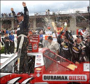 Elated Dennis Setzer finds victory is a damp experience at Michigan International Speedway after he won the Paramount Health Insurance 200 Craftsman Truck Series race yesterday.