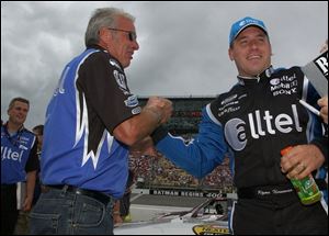 Ryan Newman is congratulated by his father after winning the pole.