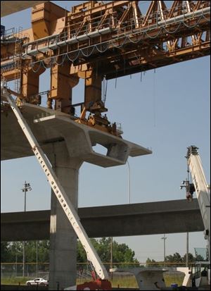 A main segment of the I-280 Maumee River bridge is installed at the site of the February, 2004, crane collapse that killed four workers. U.S. Rep. Marcy Kaptur has written to the Department of Labor, seeking their help in the criminal investigation.