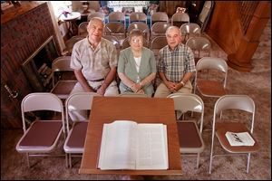 John G. Roush, left, Beneda Burkette Opelt, and house owner David L. Overmyer are in the area in which the Reformed Church of Lindsey will hold a memorial service on Sunday. 