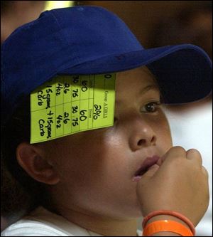 Julianna Hergenreder, 11, of Rossford, uses her hat to hold a card on which she records carbohydrates.  