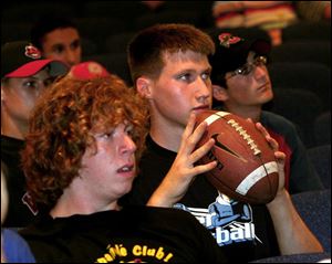 Lake High seniors Alex Maze, left, and Jeff Schulte listen as the board discusses restoring extracurricular activities.