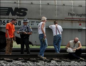 Witnesses finish giving statements after the accident that killed Naylor Cecil Squires.