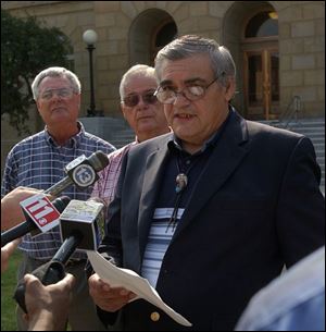 Second Chief Larry Angelo discusses the federal lawsuit filed by the Ottawa Tribe of Oklahoma, as Bert Kleiden, secretary of council, left, and Chief Charles Todd look on.