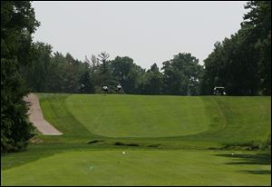 Golfers climb the hill after hitting their tee shots at Farr Classic's No. 11 hole at Highland Meadows. From the tee, the landing area is out of view.