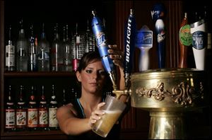 Gumbo's Bayou Grille server Shadiyah Shaheen adds to the 37,000 gallons of beer sold in the area each day.