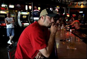 Justin Schwochow has a cigarette at the bar of Jed's Barbeque & Brew in South Toledo.