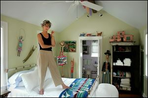 Innkeeper Tina Mather-Bothe shows off the interior of her Little Purple House bed and breakfast in Perrysburg.
