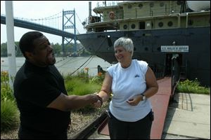 Director and actor Richard Manigault laughs with Kim Danes, the executive director of the S.S. Willis B. Boyer museum, after Mr. Manigault wrapped up filming on the ship.