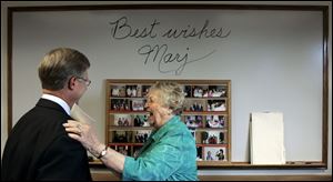 Marjorie Faust, 81, who has retired after holding a succession of public service jobs, enjoys a humorous moment with Ottawa County Commissioner Steve Arndt.