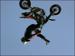 NBR motorcycle23p 04 - Preston Landers, of Texas, shows off his motorcycle skills at the Thunder at the Crossroads event at North Coast Motorcycles in Rossford.  The Blade/Allan Detrich