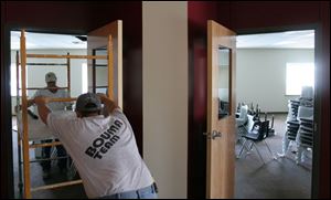 Al Merritt and his son Brian help get the Bennett Venture Academy ready in time for next month's opening. The academy is one of two facilities to compete with 60 other institutions.