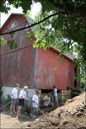 Great-grandchildren of John Luke, who purchased the land in 1877, from left, are Sally Deese, Patricia Beam, and John Neorr; Larry Miller of Archbold and Jeremy Fry help with the work.  