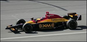 Bryan Herta drives toward his third pole of the season yesterday at Michigan International Speedway. He surprised himself with his lap of 219.141 mph.