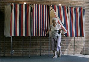 Lucile Gordon, 91, leaves the voting booth at Oak Harbor High School, at right, where she cast her ballot on the Benton-Carroll-Salem levy request. 