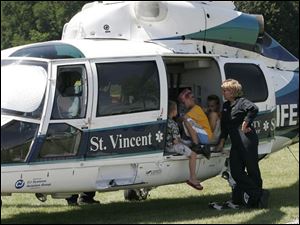NBR  lyons 30p  Lyons Ohio.  Lyons Community Park. A celebration including volleyball and baseball and BBQ chicken dinners.   l-r  Aidan Tompkins, Morenci, Hunter Hooks, Oregon, Ohio, Daniel Michael, Fayette and  Life Flight RN Mary Schafer.  The boys were hanging out  talking.  Daniel knew the nurse because he was lifeflighted  several years ago. NOTE:  I didnt make it for the parade.   The Blade/Diane Hires  7/30/04