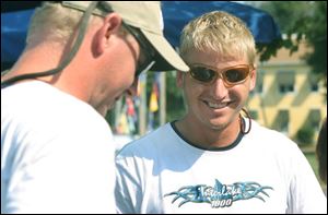 Toledo Ice Yacht Club member Brent Marriott, right, enjoys talking  with Aaron Stange after winning the Interlake fleet race in the Inter-Lake Yachting Association Regatta.