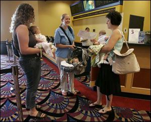 Moms and babies getting ready to see a movie at Showcase
Cinemas Levis Commons are, from left, Andrea Strayer with
daughter Ashley, April Thomas with son Drew, and Fran Jagielski
with son Aidan.