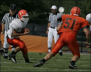 Freshman Rhett Magner tries to elude Cody Basier during a scrimmage on the same field his brother Cole starred.