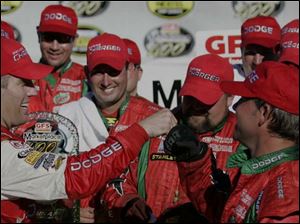 Jeremy Mayfield, left, celebrates with his pit crew after winning the GFS marketplace 400 at Michigan International Speedway in Brooklyn, Michigan yesterday.