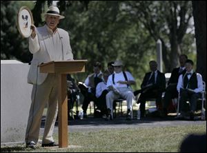 Dorsey Sergent shows off an original painting by William Jordan, who is buried at Oak Grove Cemetery. 