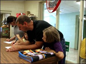 Stacey and Todd Stec enroll their girls in Crossgates Elementary
School. The Slidell, La., family is staying with family here.
