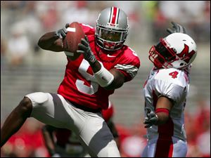 Ohio State s Donte Whitner intercepts a pass intended for Miami s Josh Williams and returns it for a touchdown. 