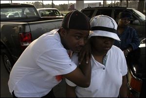 Duone Reese and his wife, Angela, wait for fuel at a gasoline station in Pascagoula, Miss. They arrived early and waited nearly three hourse because fuel is scarce.