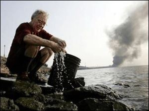 Hurricane Katrina victim Ron Seitzer, who lives in the French Quarter, washes his clothes in the Mississippi River in New Orleans.