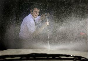 Pleasant weather is sending area motorists to car washes, such as the Minuteman on Monroe Street, where Luke Rhodes uses a pressure washer to dislodge the bugs from a windshield.