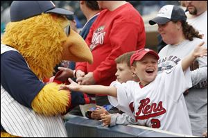 Logan Brockway is excited as Muddy roams the field autographing baseballs for his loyal followers. 