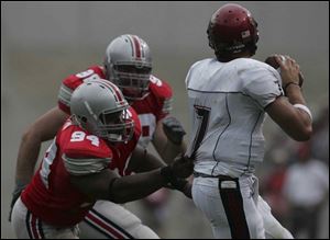 Ohio State defensive tackle Marcus Green gets a grip on quarterback Kevin O Connell.

