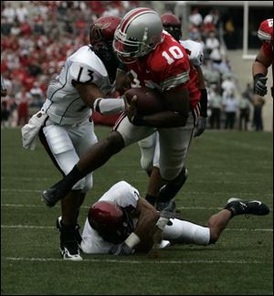 Ohio State quarterback Troy Smith eludes San Diego State defenders for the first of his two touchdowns.