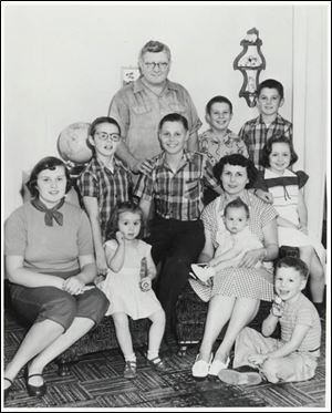 The Ryans, after winning a bicycle contest and $5,000, included, back row, father Kelly, Rog, and Bub, and, from left, Lea Anne, Bruce, Barb, Dick, mother Evelyn, Betsy (on lap), Terry, and Mike. Brother Dave was born eight months later.