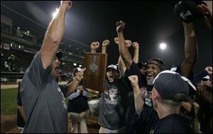Mud Hens  manager Larry Parrish, left, leads his team in celebration after winning the Governors  Cup Finals against Indianapolis on Friday morning.
