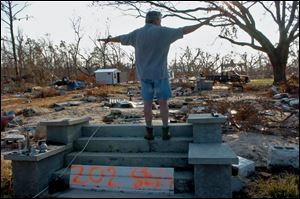 Bill Cross of Waveland, Miss., stands on the steps of what used to be his home and says,  You ll absolutely see nothing here! It s gone! It s gone! 
