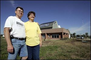 Ralph and Leah Semrock are serious about saving energy. Solar panels are visible on the roof of their house.