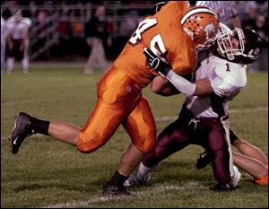 Southview s Chad Valdez, left, is brought down by Rossford s Ryan Weigand as two of the three undefeated
teams in the Northern Lakes League collided last night.
