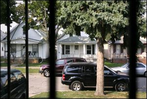 Above, Amelia Gray and her family see this view of Bronson Avenue from their porch. Crime reports since July reflect accusations by the neighbors of assault, menacing, and burglary.
