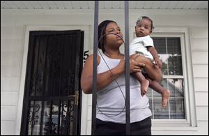 Amelia Gray, on her Bronson Avenue porch with daughter Karreen, says, 'We don't even know what the dispute is about.' 